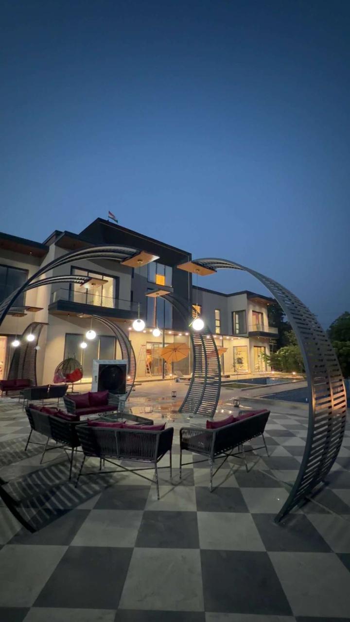 Illuminated courtyard and villa at Alvion by Bliss in Murthal